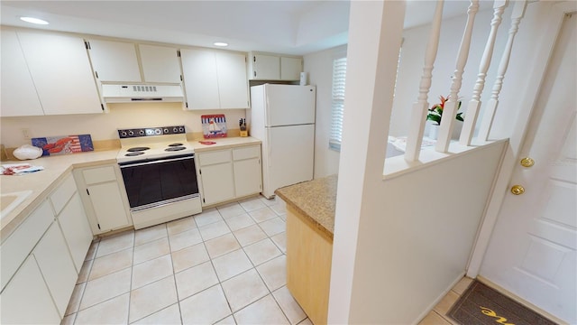 kitchen featuring ventilation hood, white appliances, and light tile patterned flooring