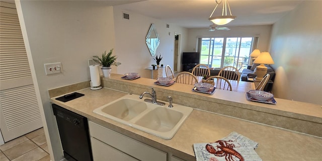 kitchen with black dishwasher, light tile patterned floors, hanging light fixtures, sink, and white cabinetry