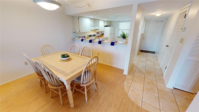 dining space with light wood-type flooring