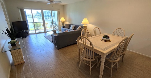 dining room featuring ceiling fan and dark hardwood / wood-style flooring