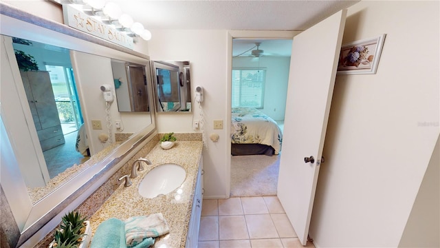 bathroom with vanity, a textured ceiling, ceiling fan, and tile patterned floors