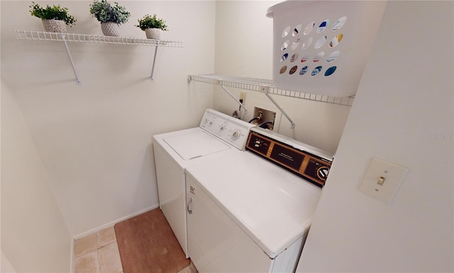 laundry room featuring light tile patterned floors and washer and clothes dryer