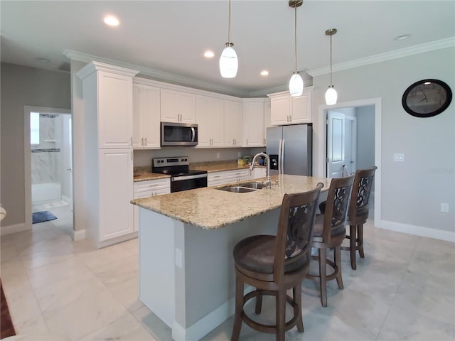 kitchen featuring white cabinets, appliances with stainless steel finishes, light stone countertops, sink, and an island with sink