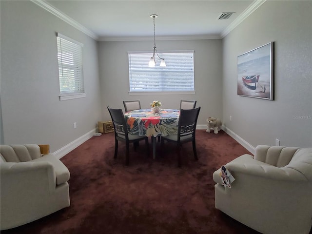 dining space featuring ornamental molding, dark colored carpet, and a chandelier