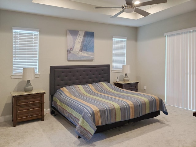 bedroom featuring light colored carpet and ceiling fan