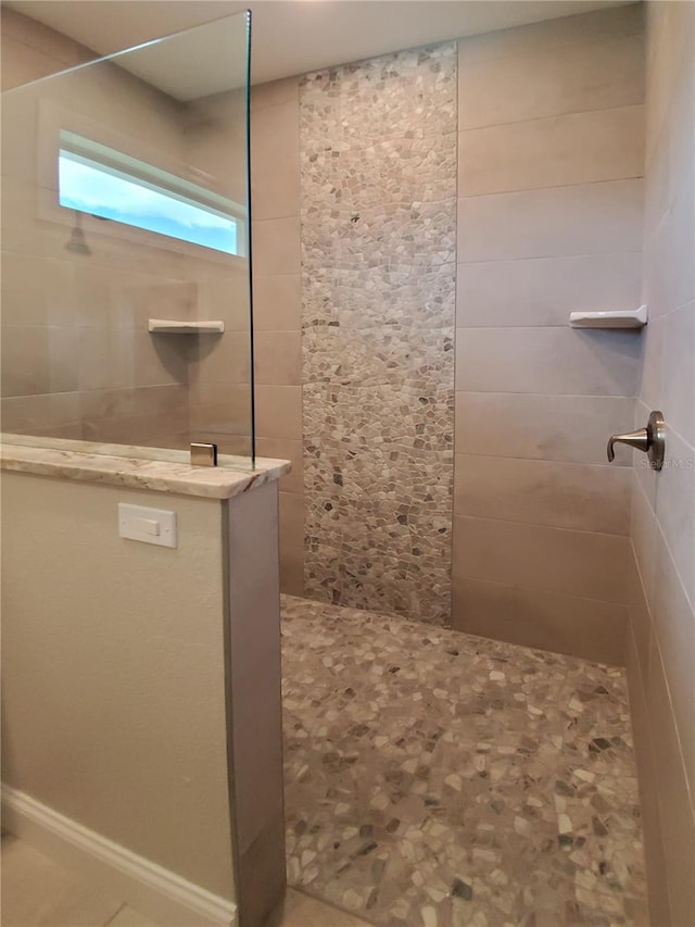 bathroom with a tile shower