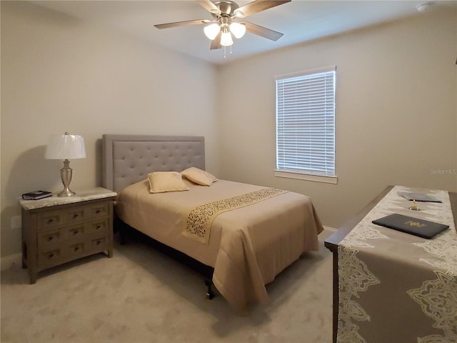 bedroom with ceiling fan and light colored carpet