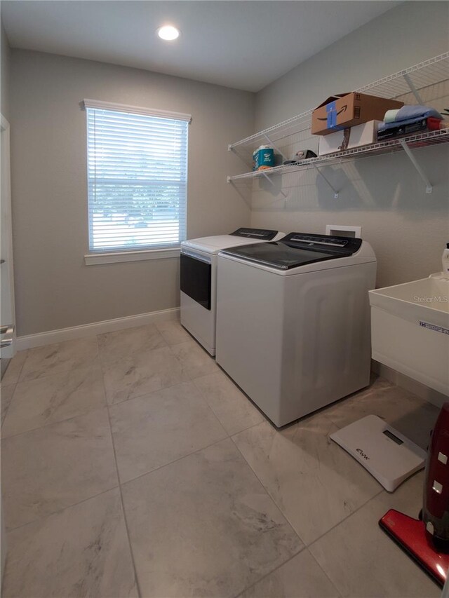 laundry room featuring sink and separate washer and dryer