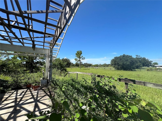 view of yard featuring a rural view and a pergola