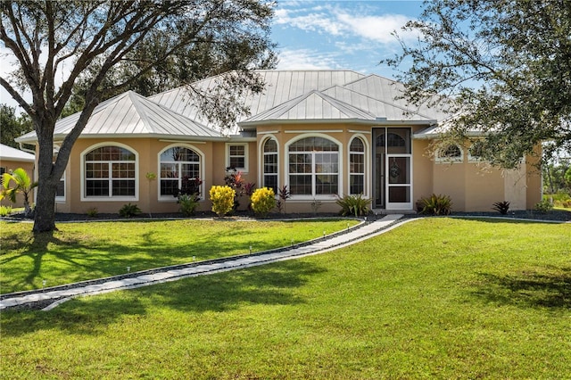 rear view of property with a lawn