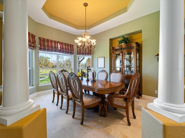 dining area with a raised ceiling and an inviting chandelier