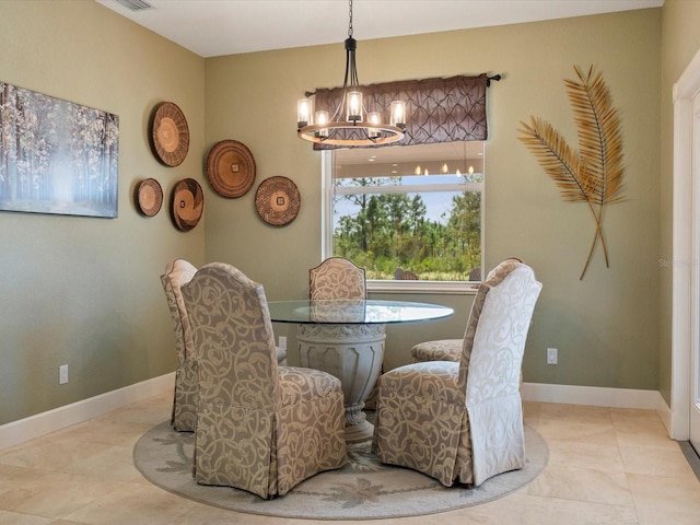 dining room with light tile patterned floors and a chandelier