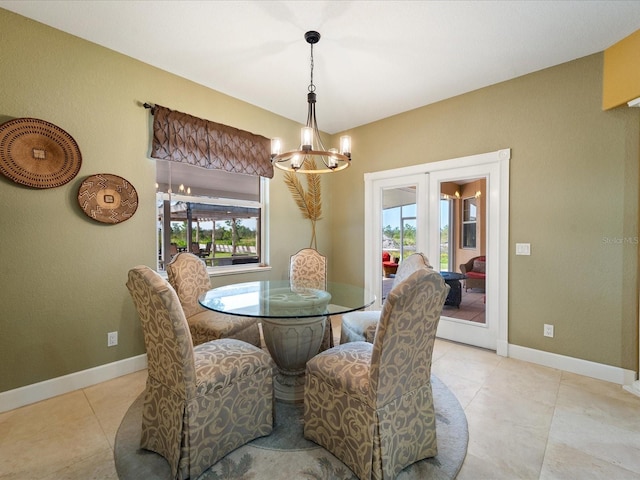 tiled dining space with a chandelier and plenty of natural light