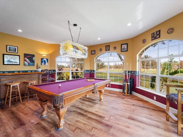 playroom with pool table, a healthy amount of sunlight, and hardwood / wood-style flooring