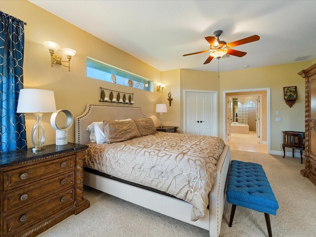 carpeted bedroom with a closet, ceiling fan, connected bathroom, and multiple windows