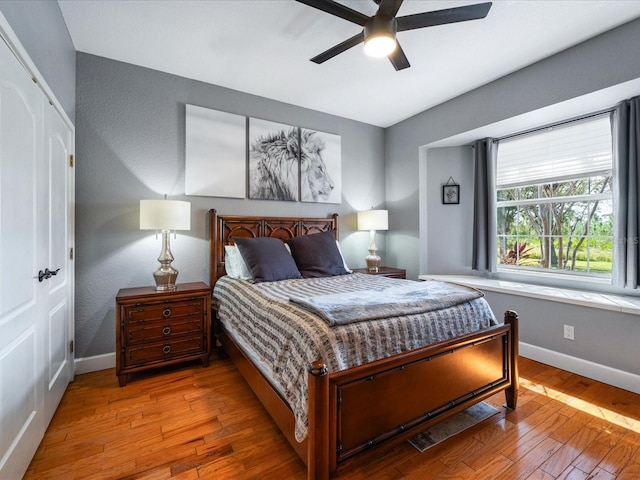 bedroom with wood-type flooring and ceiling fan