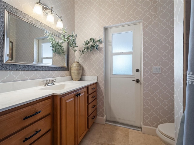 bathroom featuring vanity, toilet, and tile patterned flooring