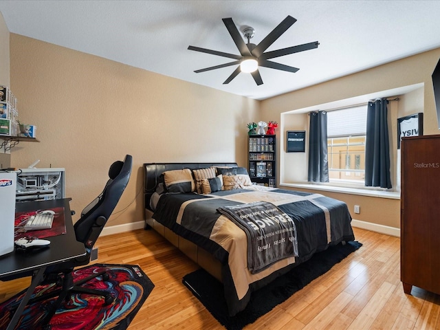 bedroom with ceiling fan and light wood-type flooring