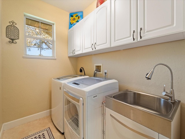 laundry area featuring cabinets, sink, washing machine and clothes dryer, and light tile patterned floors