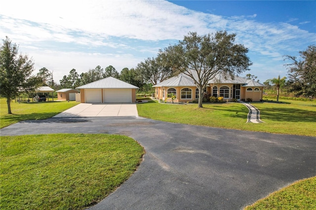 ranch-style house with a porch, an outdoor structure, a front lawn, and a garage