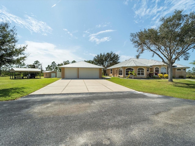 ranch-style house featuring a garage and a front lawn