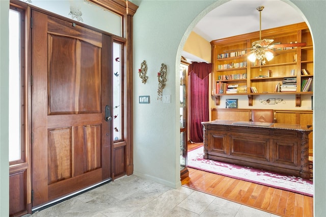 foyer entrance featuring light wood-type flooring, sink, and plenty of natural light