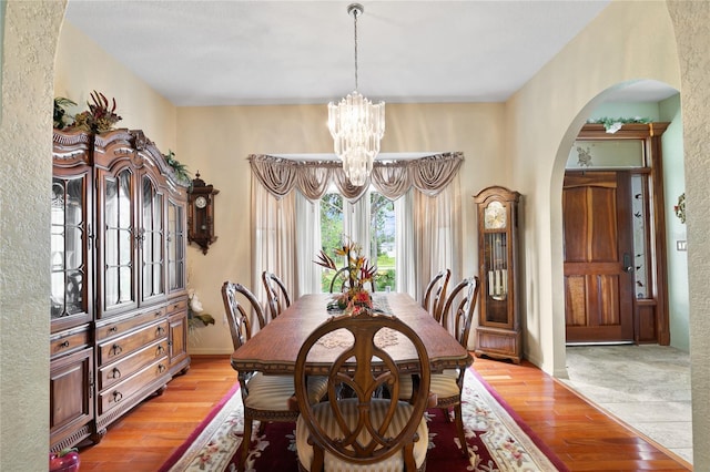 dining area with a chandelier and light hardwood / wood-style floors