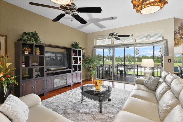 living room with vaulted ceiling, ceiling fan, and dark hardwood / wood-style floors