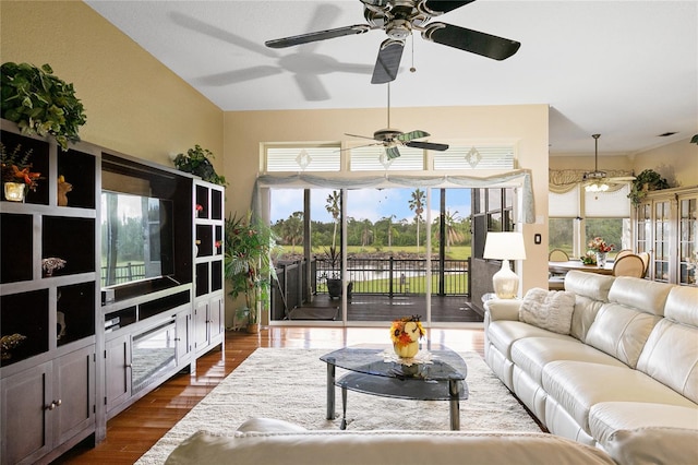 living room featuring ceiling fan, plenty of natural light, and dark hardwood / wood-style floors