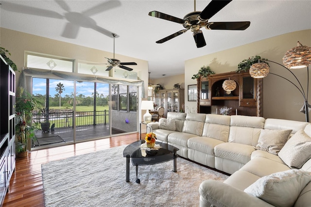 living room with wood-type flooring and ceiling fan