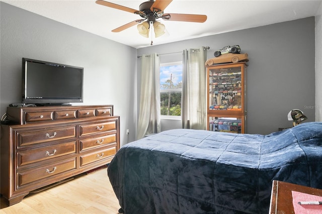 bedroom with ceiling fan and wood-type flooring