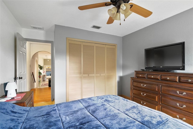 bedroom featuring ceiling fan, a closet, and light hardwood / wood-style flooring