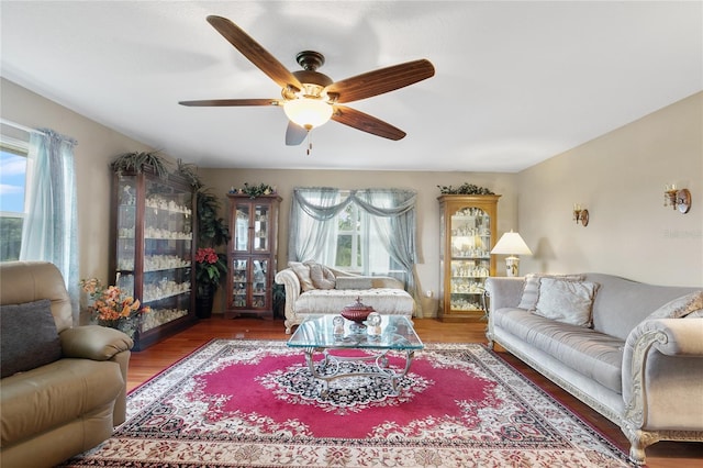 living room with wood-type flooring and ceiling fan