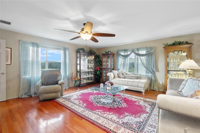 living room featuring ceiling fan, hardwood / wood-style flooring, and plenty of natural light