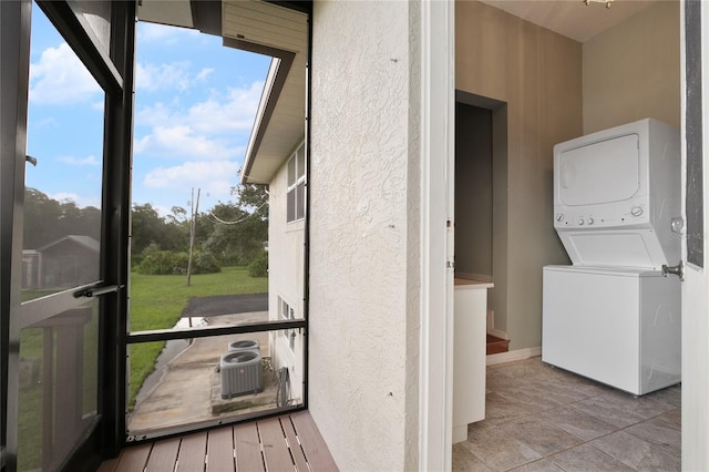 exterior space with stacked washer / dryer