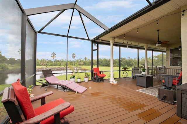 sunroom featuring a wealth of natural light, a water view, and ceiling fan