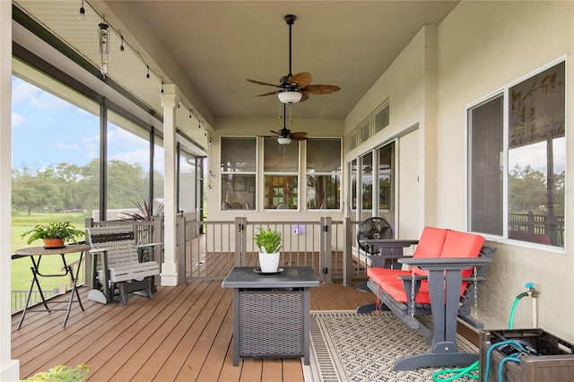 sunroom featuring ceiling fan