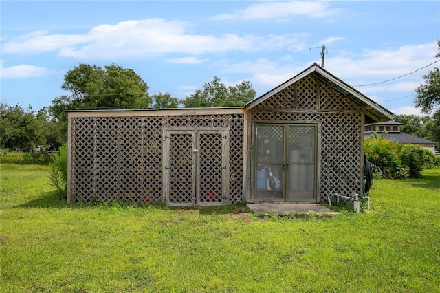 view of outbuilding with a yard