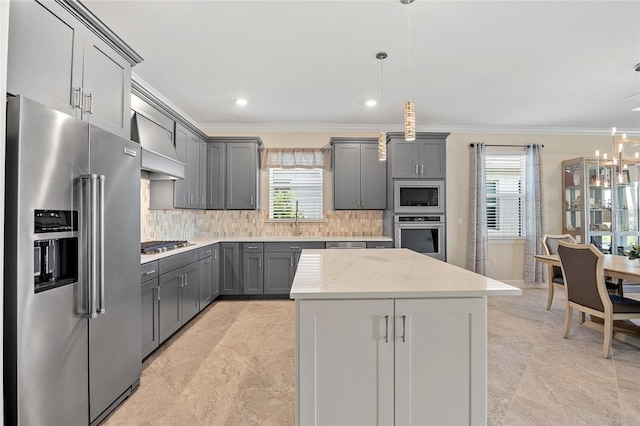 kitchen featuring gray cabinets, appliances with stainless steel finishes, a wealth of natural light, and premium range hood