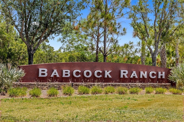 community sign featuring a lawn