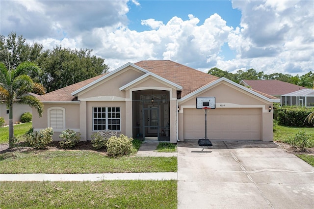 single story home featuring a front yard, driveway, an attached garage, and stucco siding