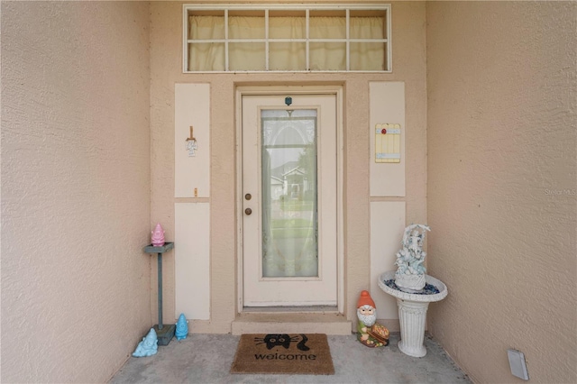 doorway to property with stucco siding