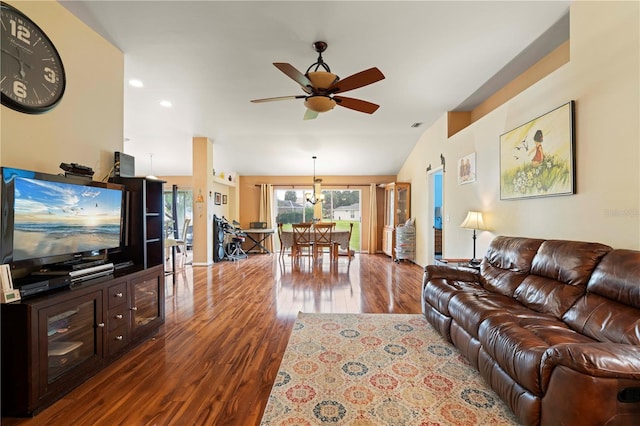 living room featuring lofted ceiling, hardwood / wood-style floors, and ceiling fan