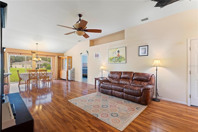 living room with vaulted ceiling, ceiling fan with notable chandelier, and hardwood / wood-style flooring