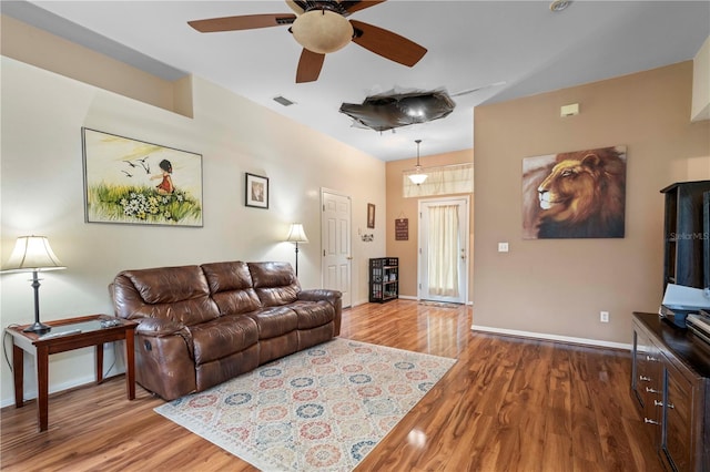 living room with wood-type flooring and ceiling fan