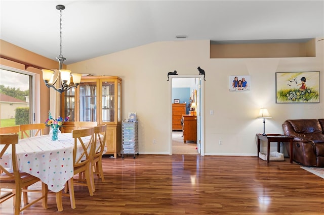 dining area with a notable chandelier, lofted ceiling, visible vents, wood finished floors, and baseboards