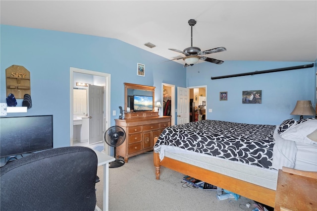 bedroom featuring a walk in closet, a closet, ensuite bathroom, and vaulted ceiling