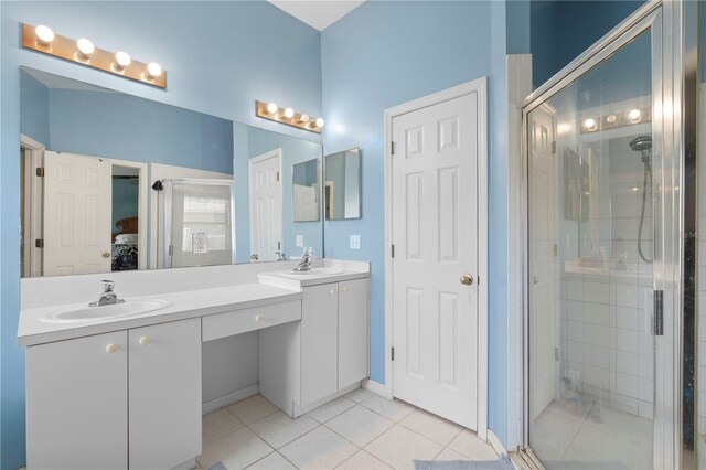 bathroom with vanity, a shower with shower door, and tile patterned flooring