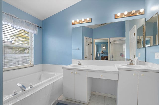 full bathroom featuring a stall shower, vanity, a garden tub, and tile patterned floors