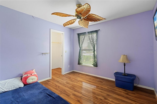 unfurnished bedroom featuring ceiling fan, wood finished floors, and baseboards